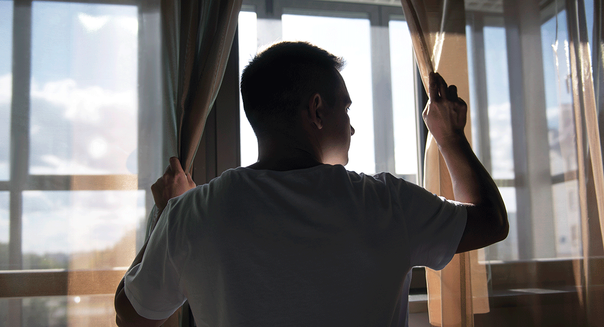 creative-portrait-man-with-curtains-shadows-from-window